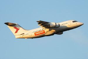 EasyJet British Aerospace Avro RJ100 D-AMGL passenger plane departure and take off at Vienna Airport photo
