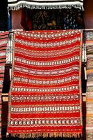 a colorful rug is displayed in front of a store photo