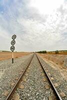 a railroad track with a sign in the distance photo