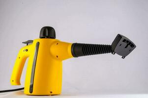 a yellow and black vacuum cleaner on a white background photo