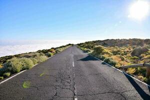 a long empty road in the middle of a desert photo