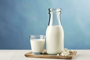 AI generated A bottle of milk and a glass of milk on a wooden table on a blue background. AI Generated photo