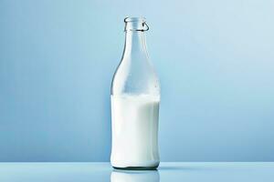 AI generated A glass bottle with full milk on blue background. photo