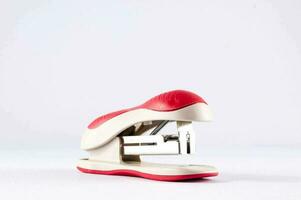 a red and white stapler photo