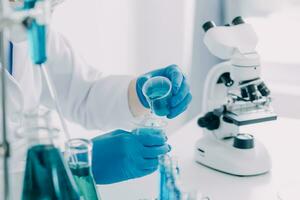 microscope with lab glassware, science laboratory research and development concept photo
