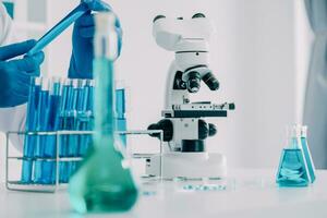 microscope with lab glassware, science laboratory research and development concept photo