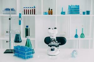 microscope with lab glassware, science laboratory research and development concept photo