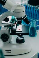 microscope with lab glassware, science laboratory research and development concept photo