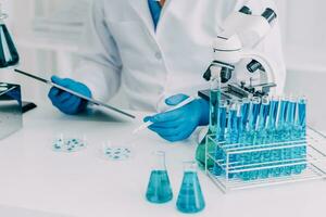 microscope with lab glassware, science laboratory research and development concept photo