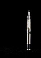 an electronic cigarette sitting on a black surface photo