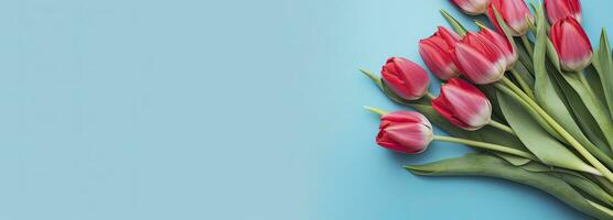 AI generated Bouquet of red tulip on blue Background. Top view with copy space. photo