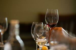 Wine glasses on a table in a restaurant, shallow depth of field photo
