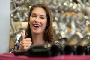 Woman looking at wine bottles in a wine store. Focus on woman photo