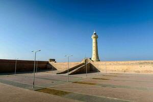 the lighthouse in the middle of a large courtyard photo