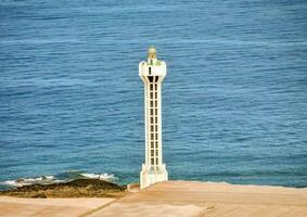 a lighthouse on the coast of spain photo