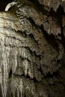 The cave is karst, amazing view of stalactites and stalagnites illuminated by bright light, a beautiful natural attraction in a tourist place. photo