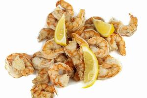 Shrimps cooked with lemon slices close-up on a white background. photo