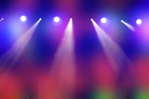 Bright multi-colored iridescent lights of stage lighting. Background scene, performance. Concert light. photo