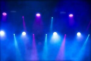 Bright multi-colored iridescent lights of stage lighting. Background scene, performance. Concert light. photo