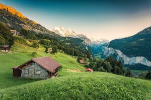 Wengen village and Lauterbrunnen valley with Jungfrau mountain in the evening at Bern, Switzerland photo