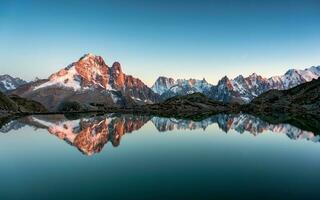 French alps landscape of Lac Blanc with Mont Blanc mountain range reflected on lake in the sunset at Chamonix, France photo