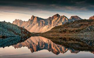 View of Lac Long with massif Des Cerces reflection on the lake in Claree valley at  France photo