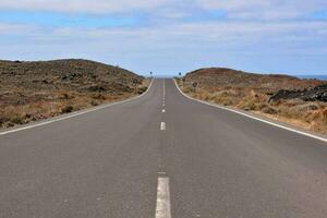 an empty road and a blue sky photo