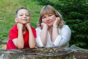 Happy mom and son on a summer walk look at the camera smiling. photo