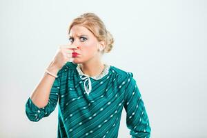 Retro woman holding nose because of unpleasant smell photo