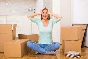 Woman screaming in panic because of too much things to do while moving into new home. photo