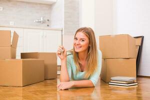 Beautiful woman holding key of her new home. photo