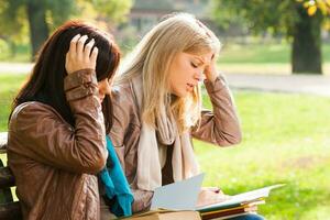 Exhausted students with books photo