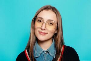 Close up shot of stylish young woman in sunglasses smiling photo