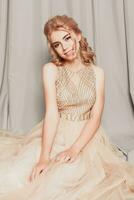 Fashion model in beautiful luxury beige flowing chiffon dress photo