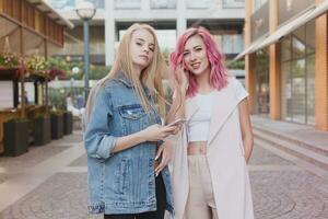 Two young women laughing and walking enjoying carefree vacation lifestyle photo