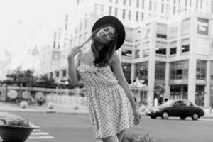 A young teenage girl in a white dress and hat photo