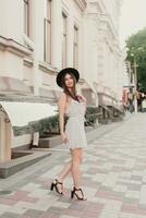 A young teenage girl in a white dress and hat photo