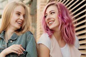 Two young women laughing and walking enjoying carefree vacation lifestyle photo