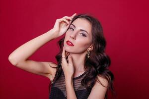 Beautiful young woman in elegant black cocktail dress photo