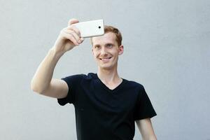 Close up portrait of a redhead of a beautiful manly guy with freckles photo