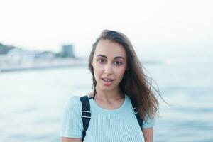 individuality portrait of a beautiful young woman at the sea photo