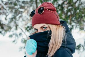 Winter woman blowing snow in a park photo