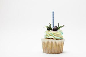 birthday cupcake with one burning candles over white background photo