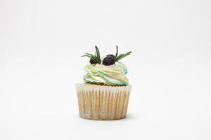 birthday cupcake with one burning candles over white background photo