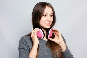 happy woman or teenage girl in headphones listening to music photo