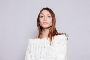 Beautiful woman face close up portrait young studio on gray photo