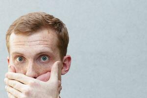 Close up portrait of a redhead of a beautiful manly guy with freckles photo