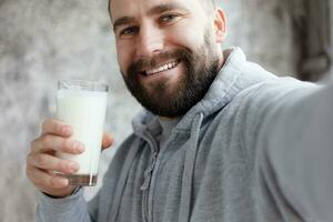 Young man drinking milk photo