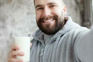 Young man drinking milk photo