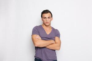 Handsome young man on grey background looking at camera photo